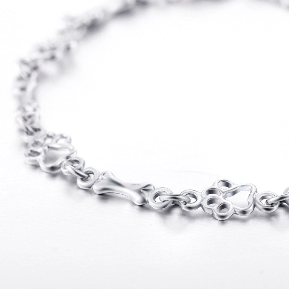 Pulseira de prata sólida com pendentes de pata e osso de cão