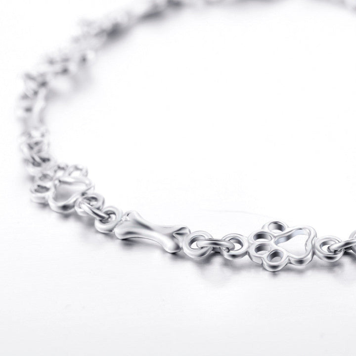 Pulseira de prata sólida com pendentes de pata e osso de cão